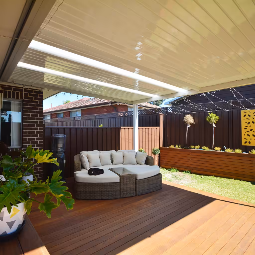 DIY attached flat roof patio with circular seating and plants