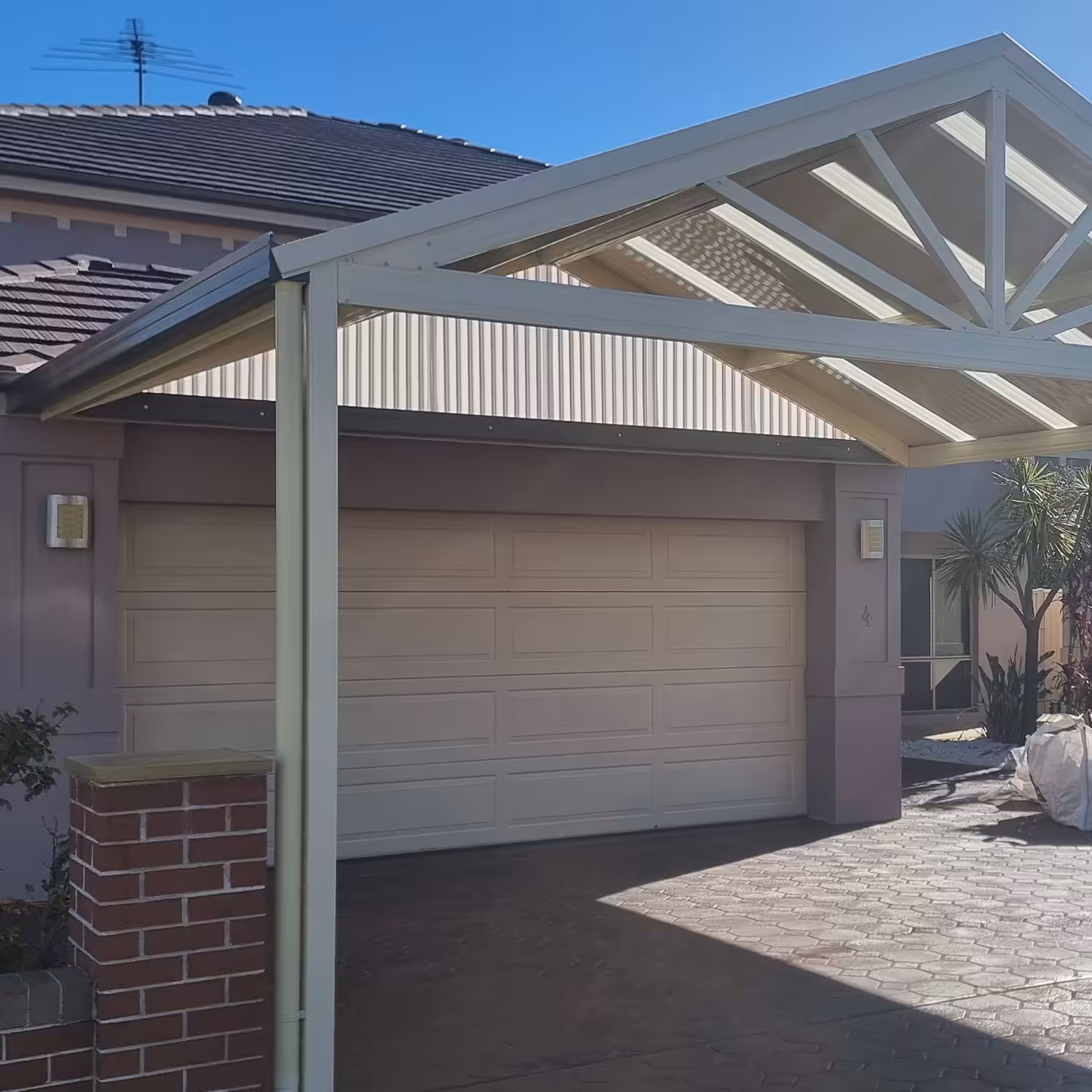 Modern house with diy freestanding gable roof carport kits