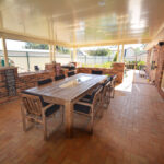 Spacious outdoor DIY attached flat roof pergola/patio with wooden furniture