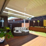 Inviting outdoor seating area under a DIY attached flat roof pergola/patio
