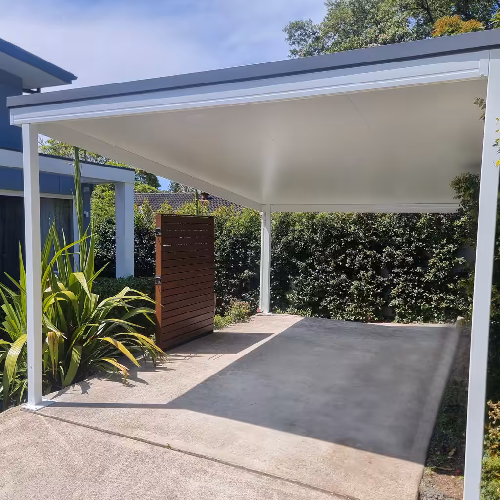 Modern DIY attached flyover flat roof patio/pergola with landscaped garden in background.