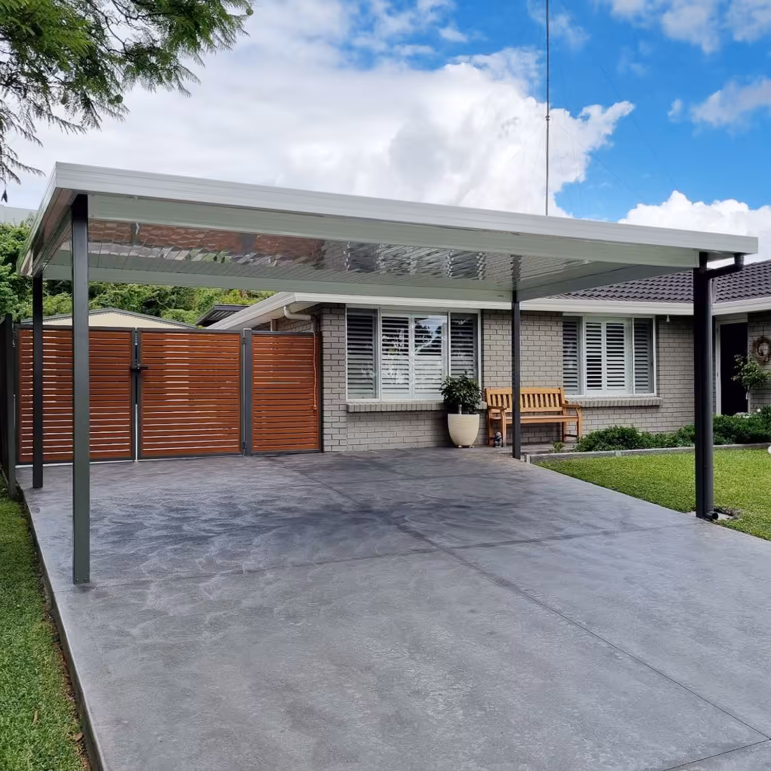 Modern diy freestanding flat roof carport in front of suburban Australian home.