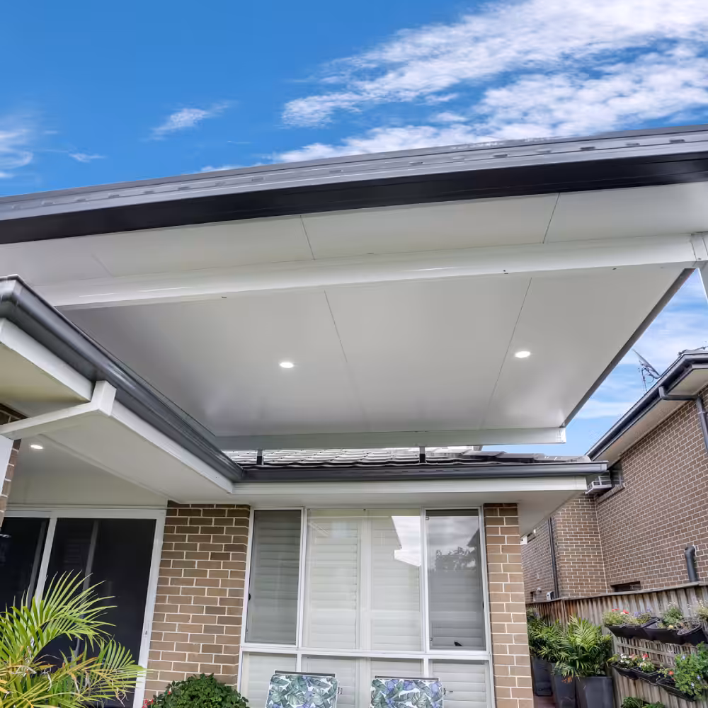 A DIY attached flyover flat roof patio/pergola with lights.