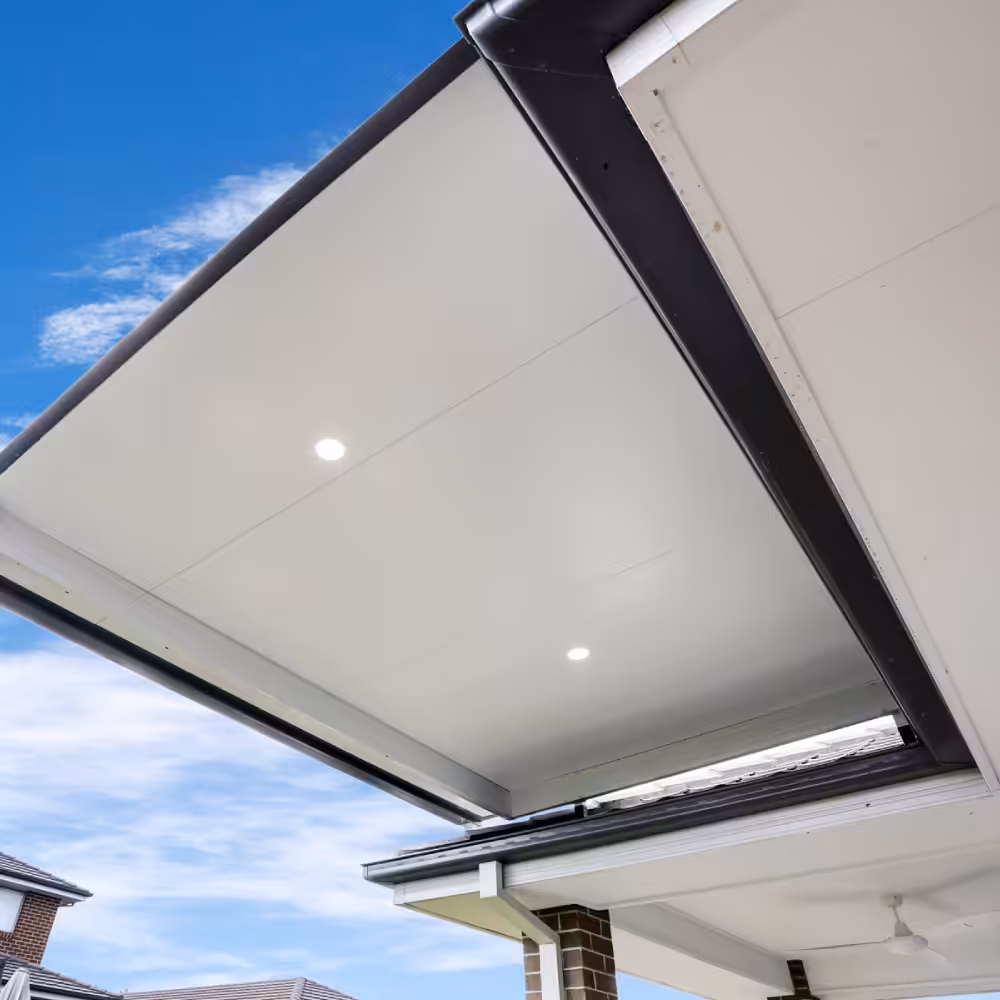 DIY attached flyover flat roof patio/pergola with downlights against blue sky.
