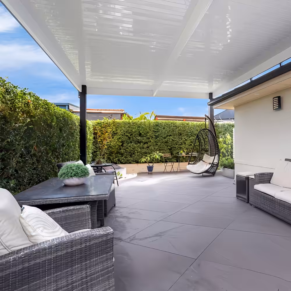 DIY attached flyover flat roof patio/pergola with seating and greenery.