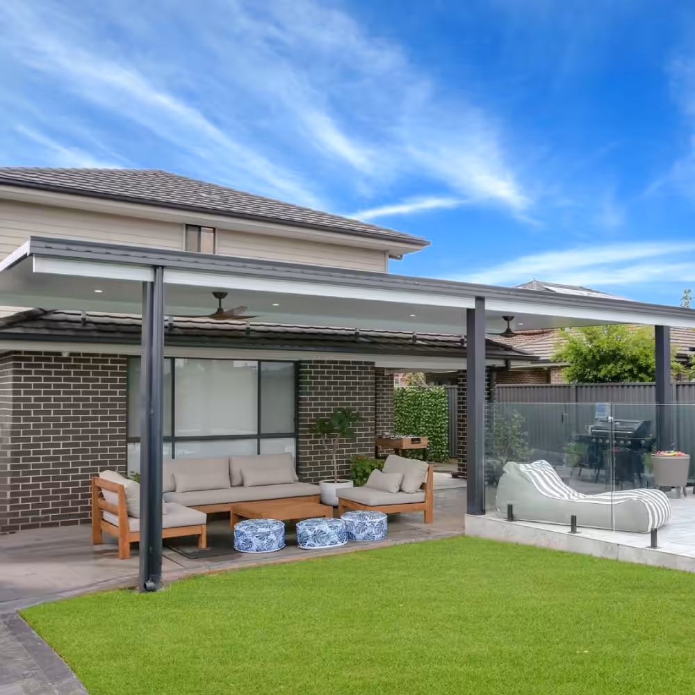 DIY attached flyover flat roof patio/pergola with green lawn and furniture.