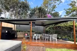 Outdoor patio area with seating and BBQ grill.