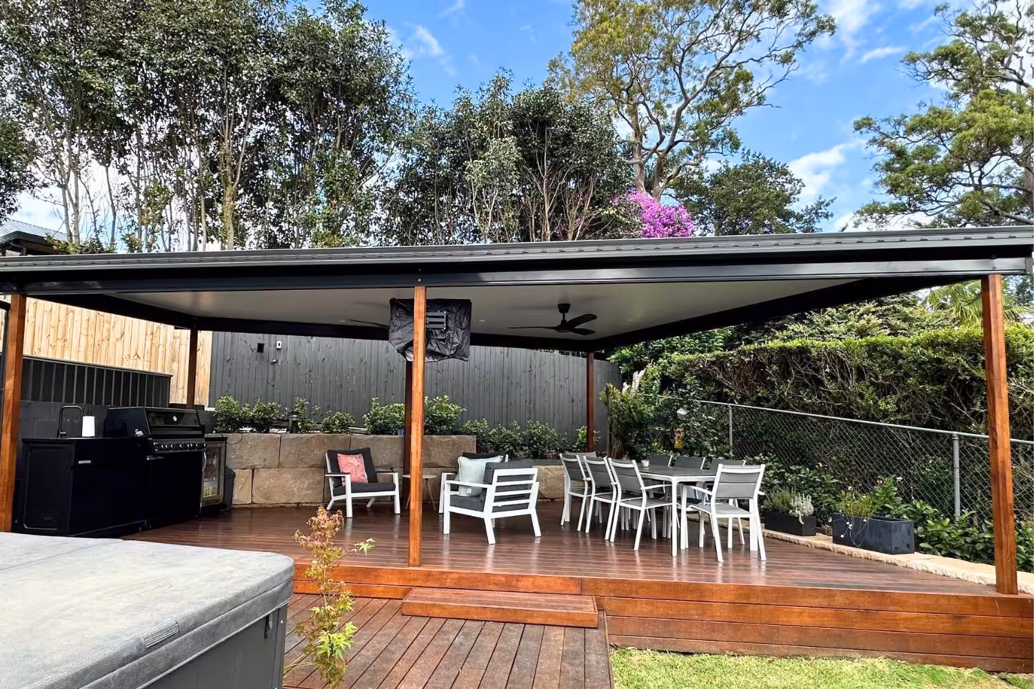 Outdoor patio area with seating and BBQ grill.
