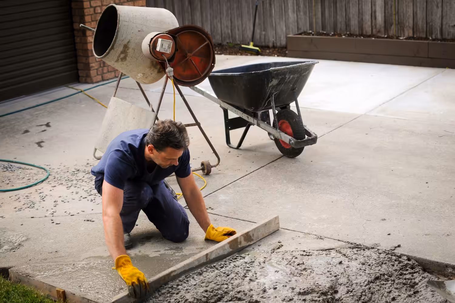 Man smoothing concrete on a construction site.